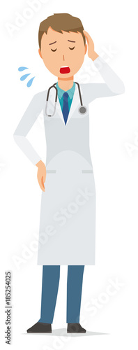 A young male doctor in a white suit is tired