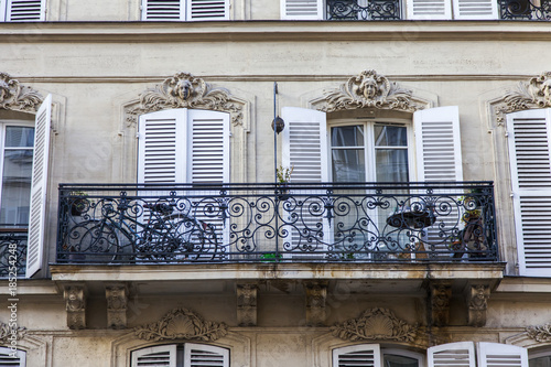 PARIS, FRANCE, on October 30, 2017. The sun lights the city street and typical architectural parts of houses of in downtown. Building facade fragment photo