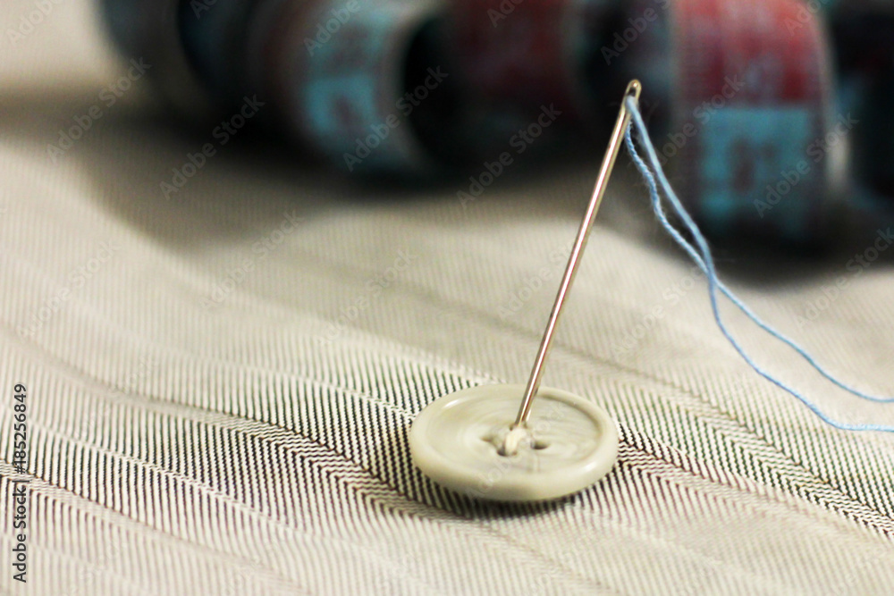 needle with thread and buttons