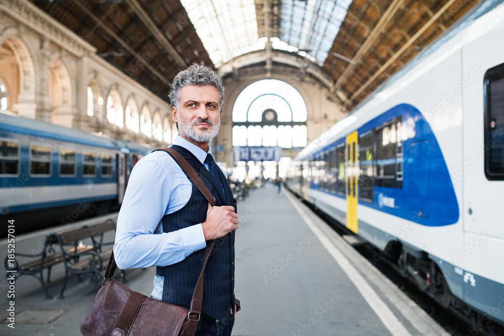 Mature businessman on a train station. Mature businessman on a train station.