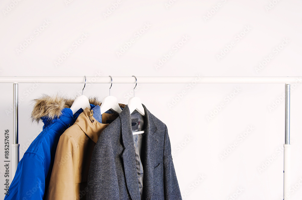 Outer clothing on the shoulders on the dressing counter. Shoes and bags on the floor. On a white background. Outer clothing on the shoulders on the dressing counter. Shoes and bags on the floor. On a white background.