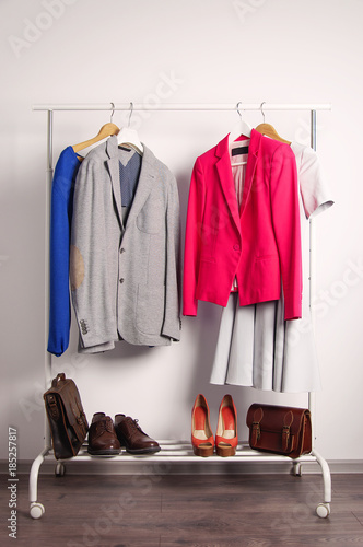 Outer clothing on the shoulders on the dressing counter. Shoes and bags on the floor. On a white background.