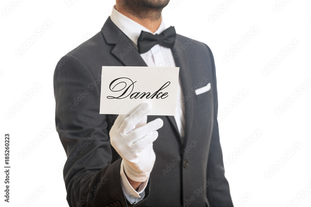 Waiter holding a card with Danke on white background Waiter holding a card with Danke on white background