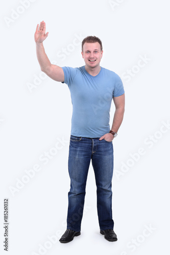 smiling young man raising hand up