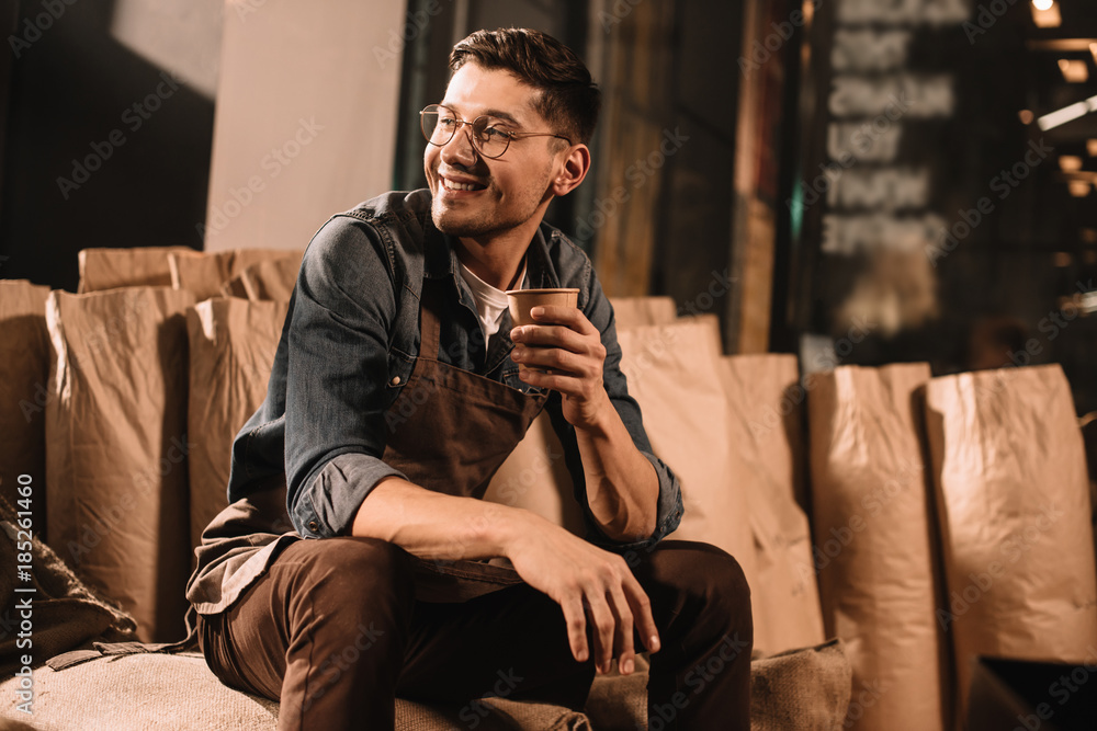 smiling coffee roster with cup of coffee having break during work smiling coffee roster with cup of coffee having break during work