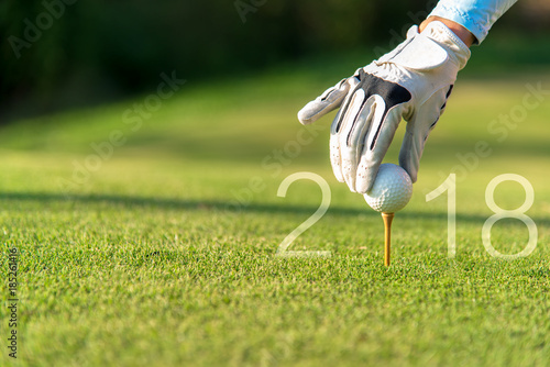 Golfer asian woman putting golf ball for Happy New Year 2018 on the green golf, copy space. Healthy and Holiday Concept..