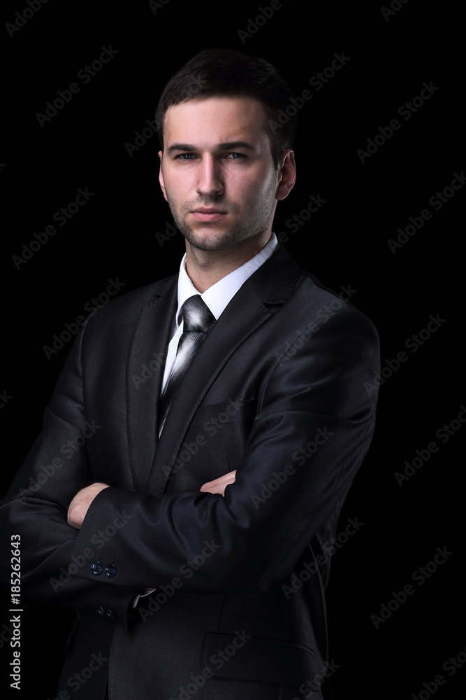 Portrait of a handsome business man isolated on black. Portrait of a handsome business man isolated on black.