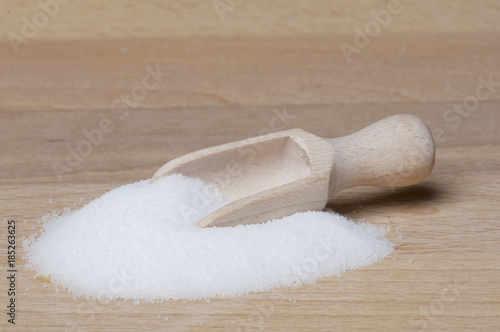Salt on table with wooden spoon 