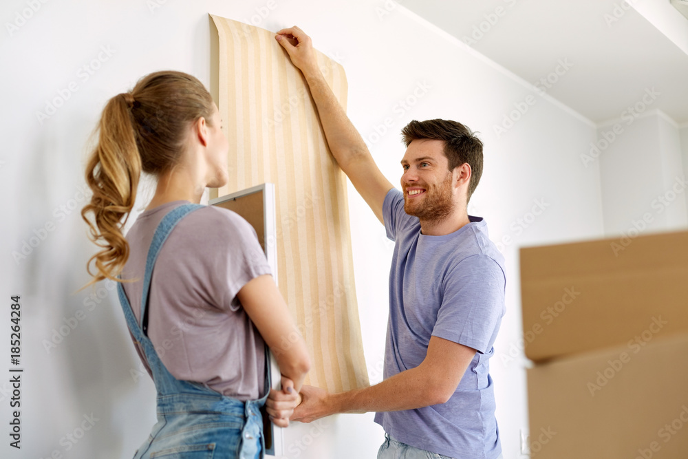 couple with wallpaper repairing apartment or home couple with wallpaper repairing apartment or home