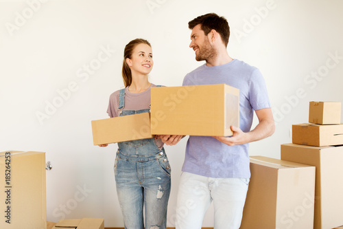 happy couple with boxes moving to new home