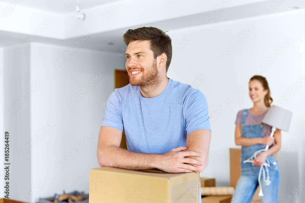 happy couple with boxes moving to new home happy couple with boxes moving to new home