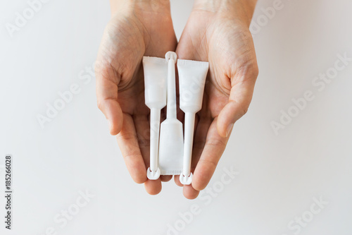 hand holding tubes of micro enema photo