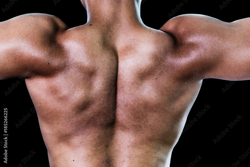 Unrecognizable Strong bald bodybuilder with six pack personal fitness trainer flexing his muscles Unrecognizable Strong bald bodybuilder with six pack personal fitness trainer flexing his muscles