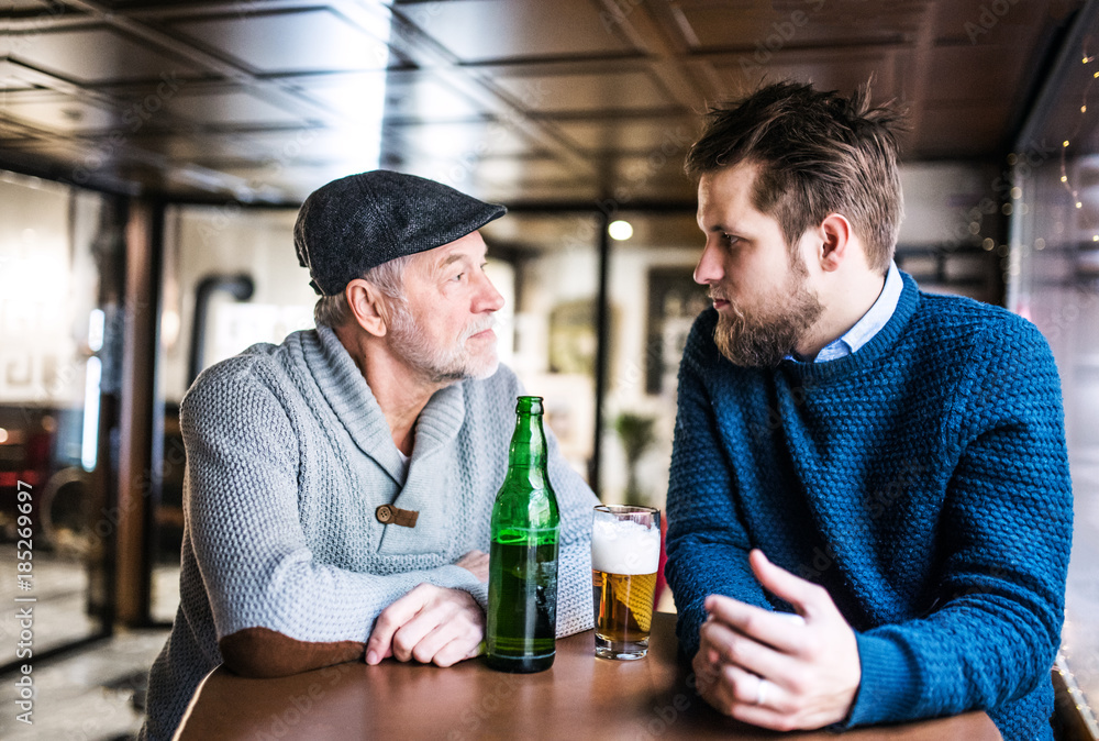 Senior father and his young son in a pub. Senior father and his young son in a pub.