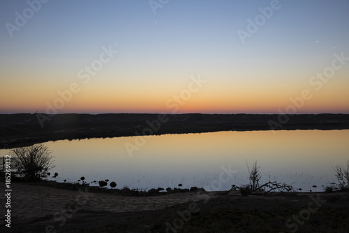 sunset with shy reflection in still water over nature reserve Casse de la Belle Henriette, Vendee, France