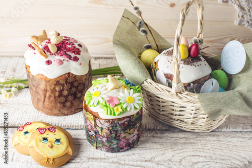 Festive table with cake and colorful eggs on wooden background. Concept of Orthodox Easter