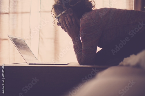 woman on sofa working at the comuter photo