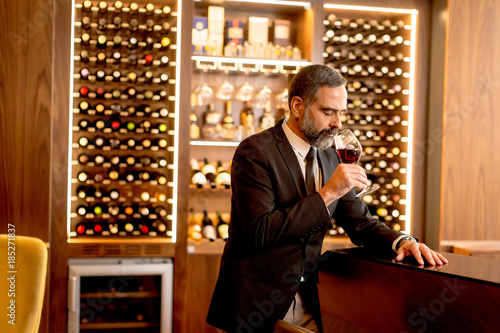 Handsome mature man tasting...