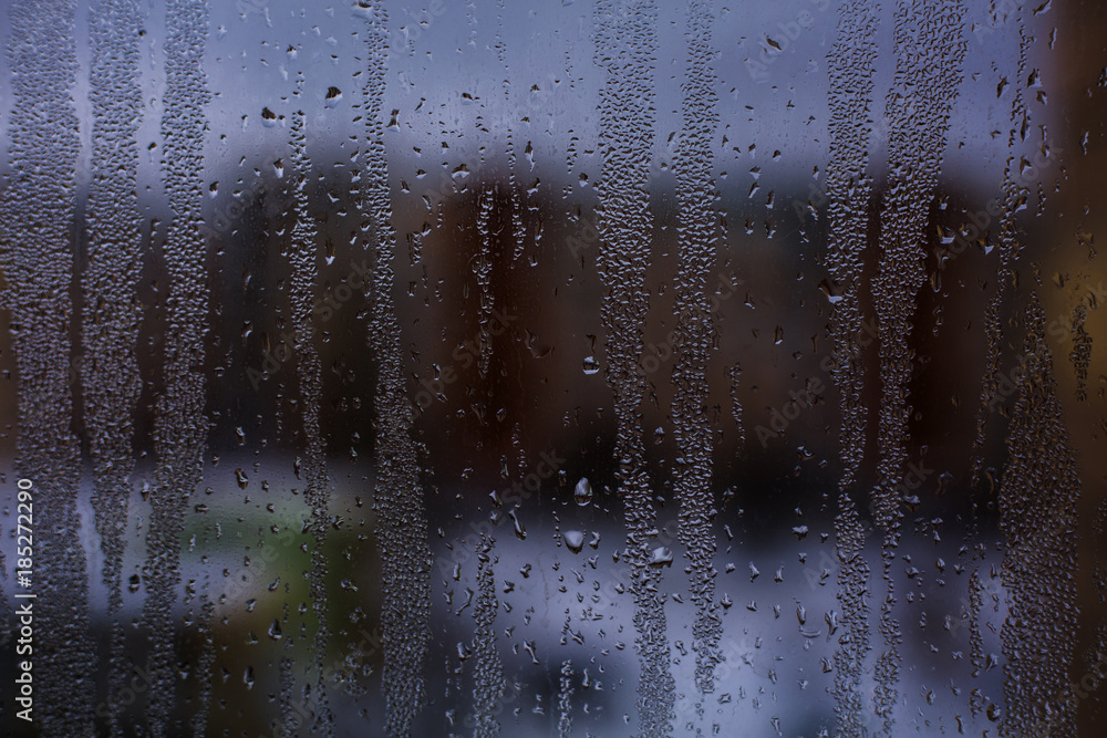 Misted window glass in drops of water as a background Misted window glass in drops of water as a background