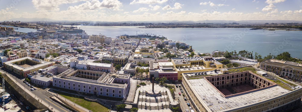 180 degree aerial panorama of Old San Juan, Puerto Rico with harbor in the background.