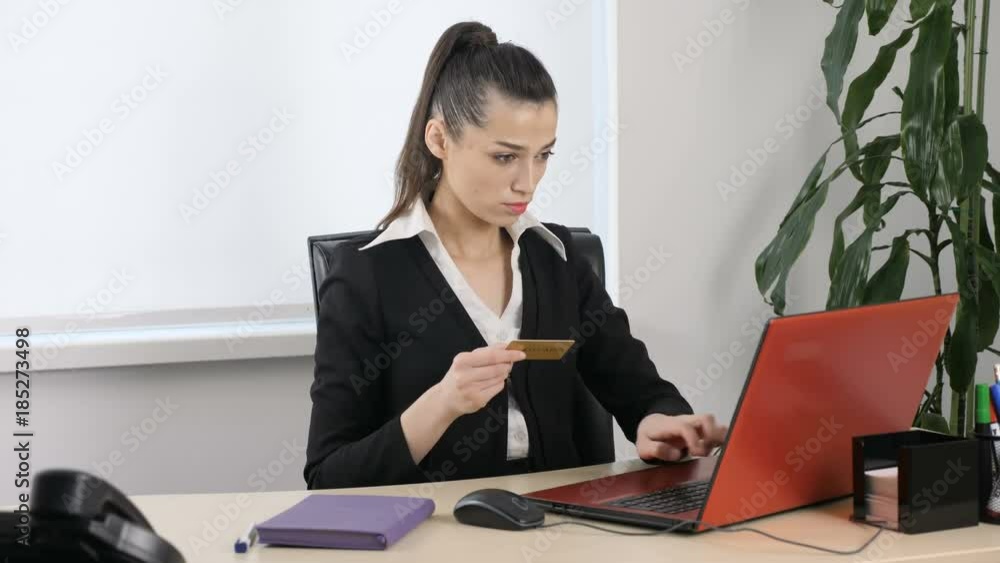 Young attractive girl enters data from credit card into laptop for online purchase 60 fps Young attractive girl enters data from credit card into laptop for online purchase 60 fps