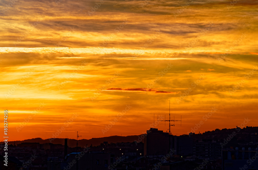 Colorful sunset over roofs of Barcelona, Spain