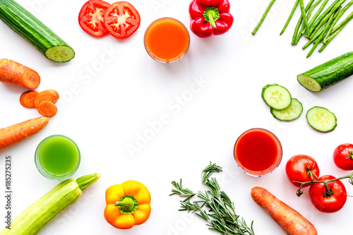 Wellness elements. Colorful detox drinks with vegetables on white background top view copyspace