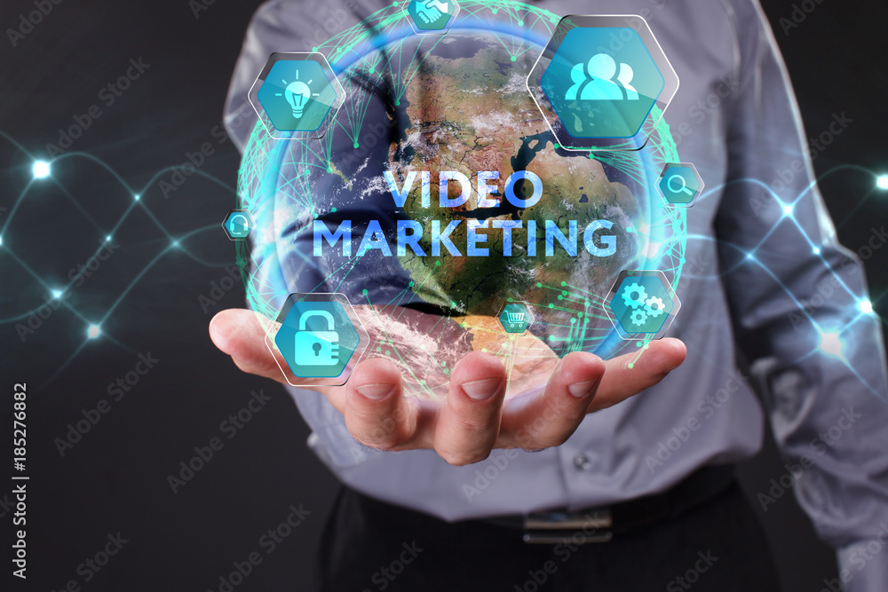 The concept of business, technology, the Internet and the network. A young entrepreneur working on a virtual screen of the future and sees the inscription: Video marketing The concept of business, technology, the Internet and the network. A young entrepreneur working on a virtual screen of the future and sees the inscription: Video marketing