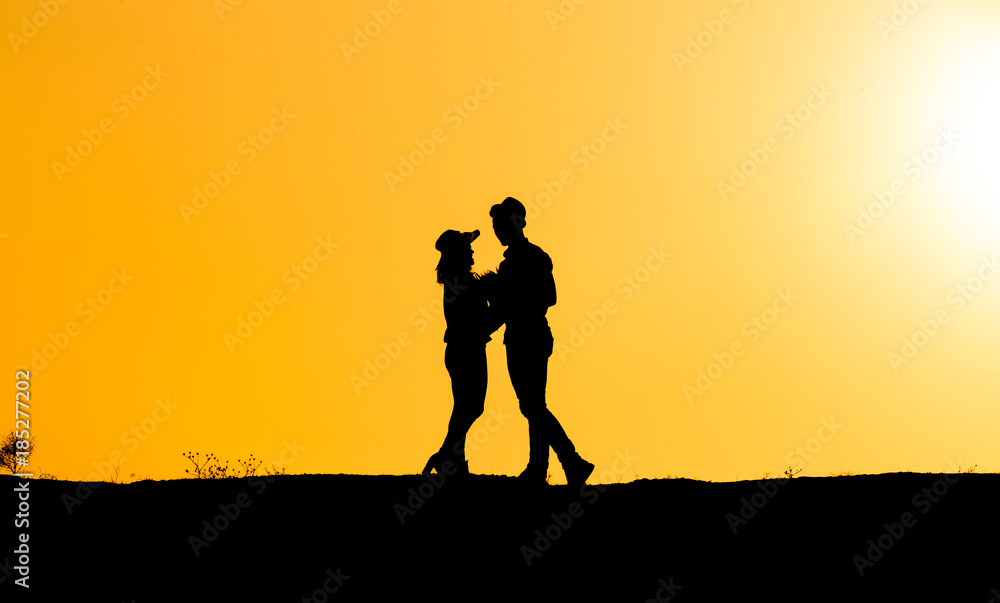 young couple silhouette at sunset