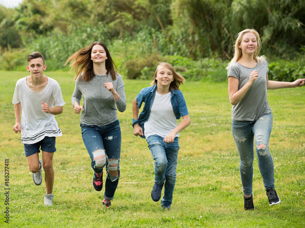 Fototapeta premium Friends having fun and running in park