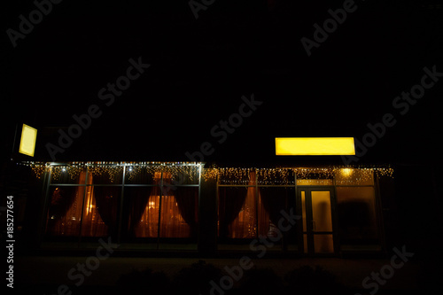 Cafe with lighting and garlands, festive restaurant for merry christmas and other winter holidays