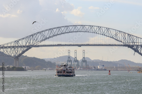 Tourist boat cruising trhough the Panamá Canal, bridge of the Americas