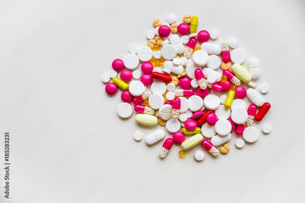 Assorted pharmaceutical medicine pills, tablets and capsules.Pills background. Heap of assorted various medicine tablets and pills different colors on white background. Health care.Top view.Copy space Assorted pharmaceutical medicine pills, tablets and capsules.Pills background. Heap of assorted various medicine tablets and pills different colors on white background. Health care.Top view.Copy space