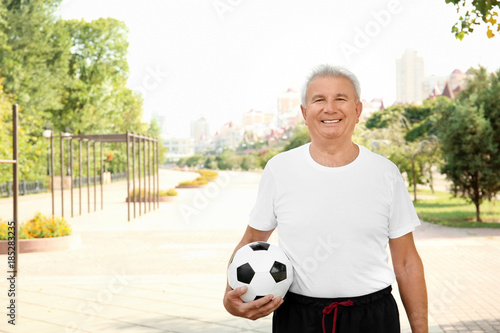 Mature man with soccer ball...