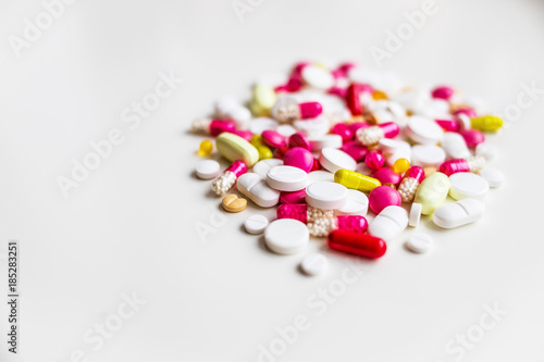 Assorted pharmaceutical medicine pills, tablets and capsules.Pills background. Heap of assorted various medicine tablets and pills different colors on white background. Health care.Top view.Copy space
