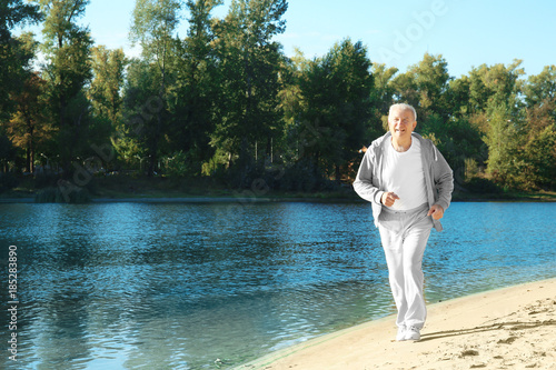 Mature man running near river