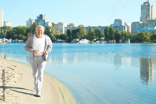 Mature man running near river