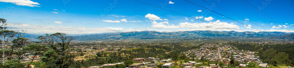 Fototapeta premium Beautiful panaramic view of buildings surrounding of mountains, to visit municipal dump in a beautiful day, in the city of Quito, Ecuador