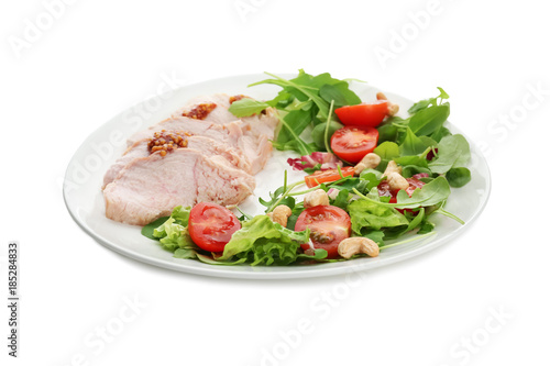 Plate with meat and delicious vegetable salad on white background