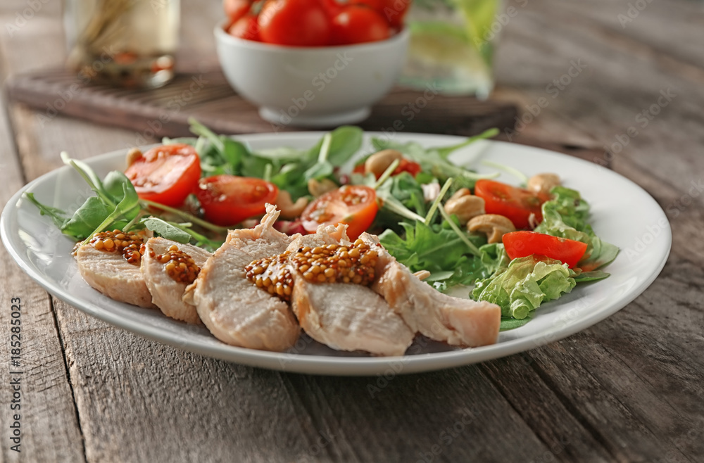 Plate with meat and delicious fresh salad on table Plate with meat and delicious fresh salad on table