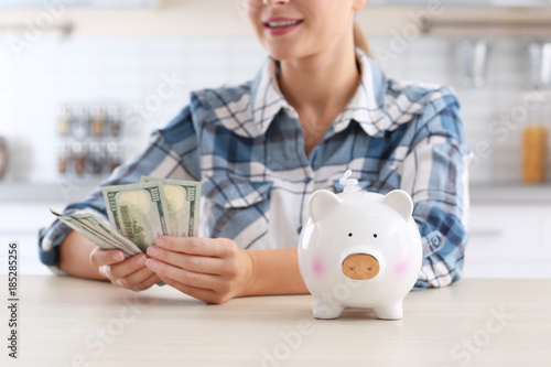 Woman with piggy bank and m...
