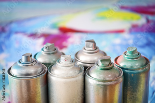 Aluminum aerosol cans with paints, closeup