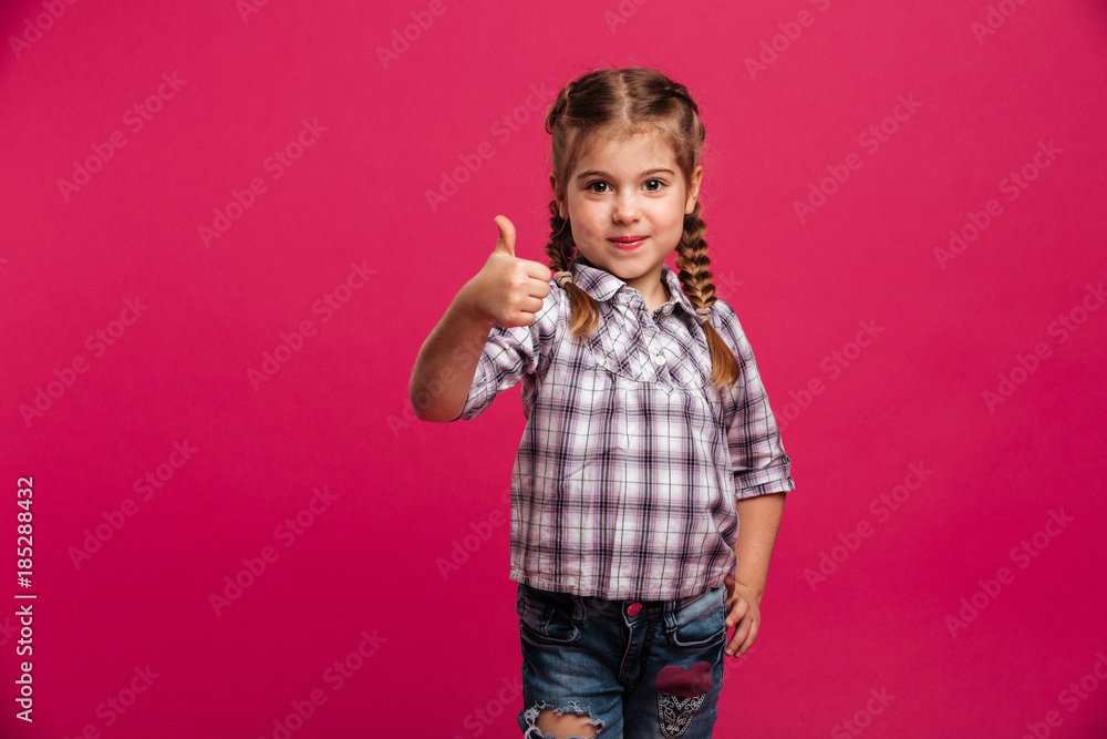 Happy little girl child showing thumbs up. Happy little girl child showing thumbs up.