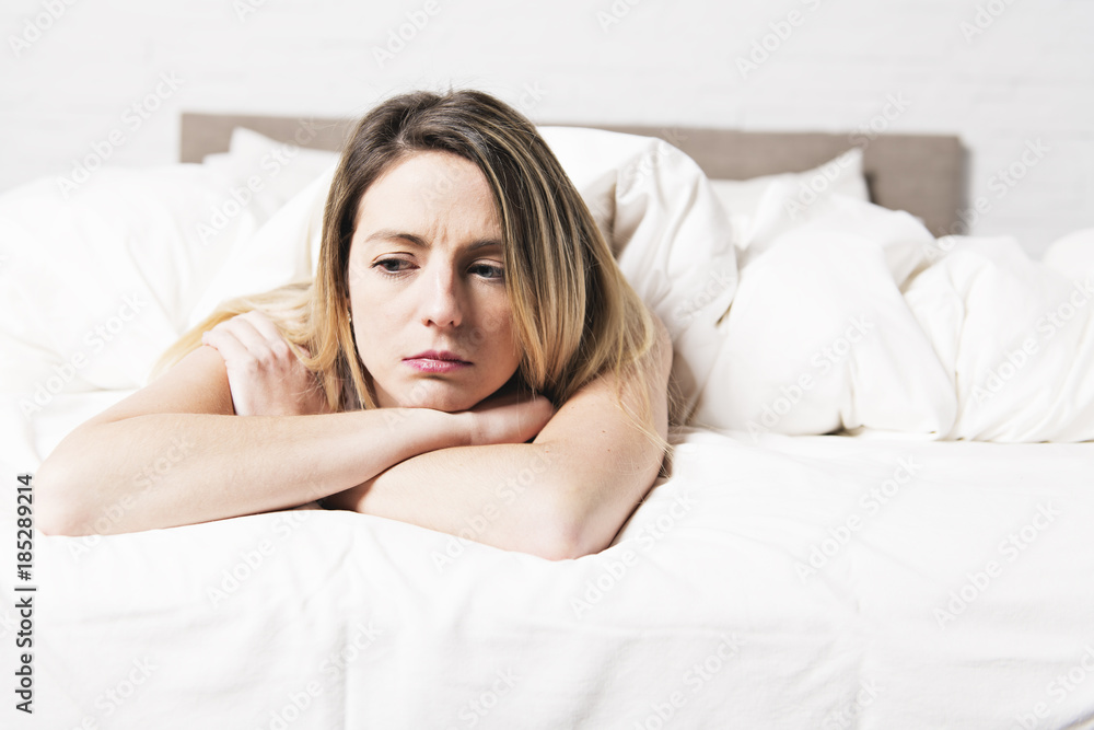 unhappy mature female in bed at bedroom unhappy mature female in bed at bedroom