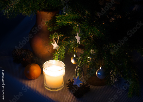 Рождественский фон с огнем свечи  и украшениями. 