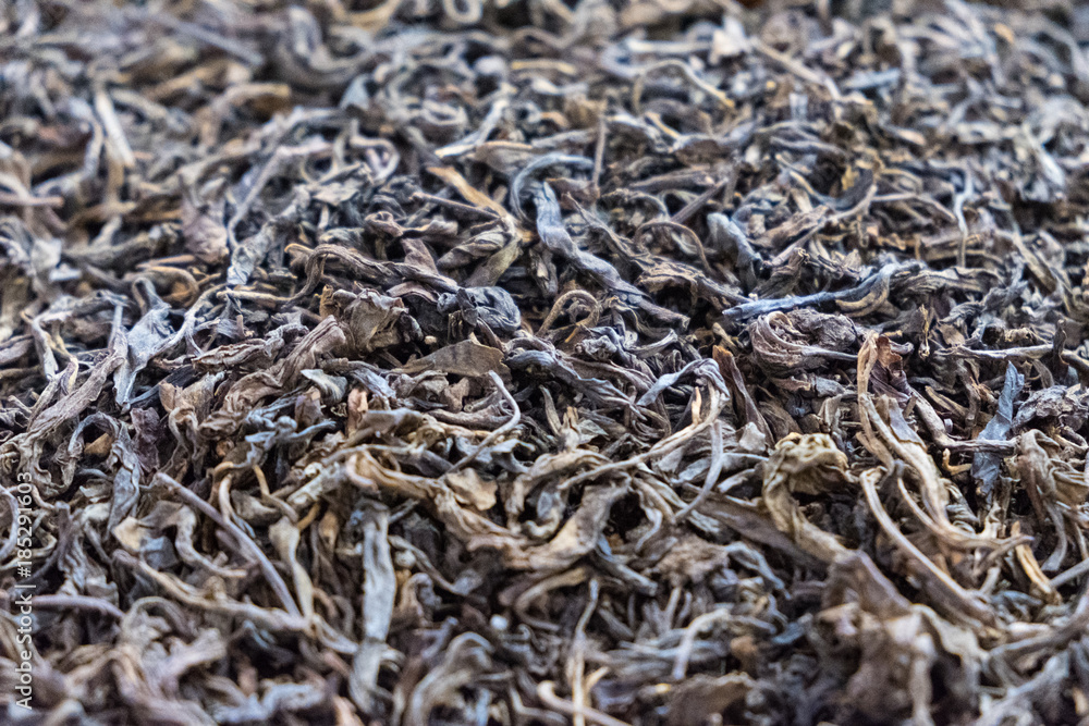 Dried black tea leaf background close up photo Dried black tea leaf background close up photo