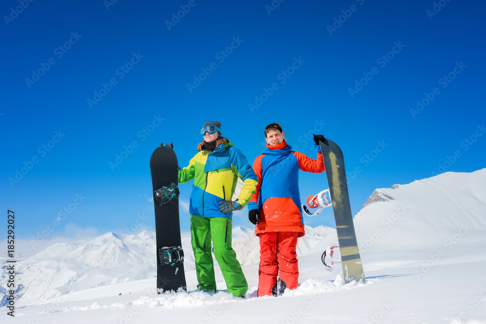 pair of snowboarders a man and a woman