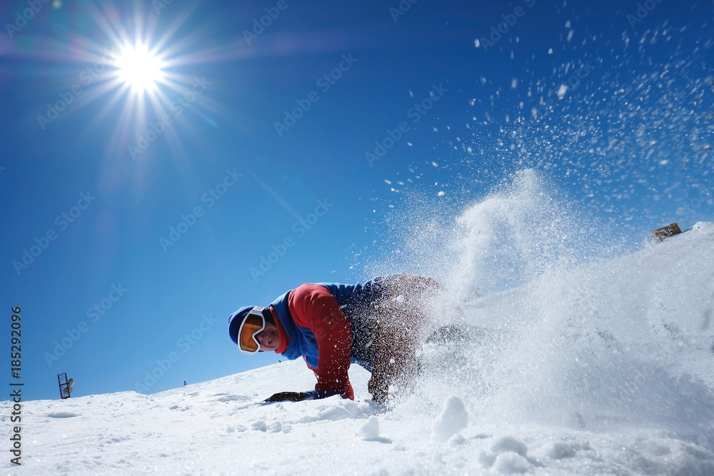 male athlete snowboarder falls on snow