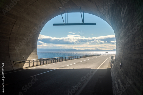 View from the tunnel to the blue cloudy sky and the sea, Finnmark, Norway © natagolubnycha