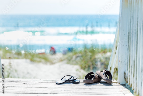 Obraz na płótnie Sandals on the boardwalk by the beach